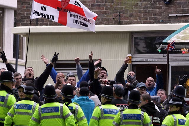 EDL members demonstrate behind police in Bristol today