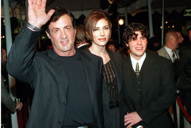 Father and son: Stallone arrives at a 1996 film premier with girlfriend Jennifer Flavin, center, and his son Sage