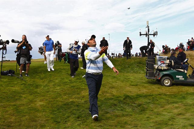 Francesco Molinari throws his ball to the crowd after taking a 17-under-par, one-shot lead into today's final round of the Scottish  Open at Castle Stuart