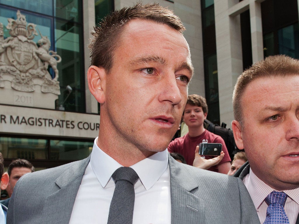 Clean cut?: John Terry leaves court having been found not guilty of racism. But he still has questions to answer and now football is in the dock