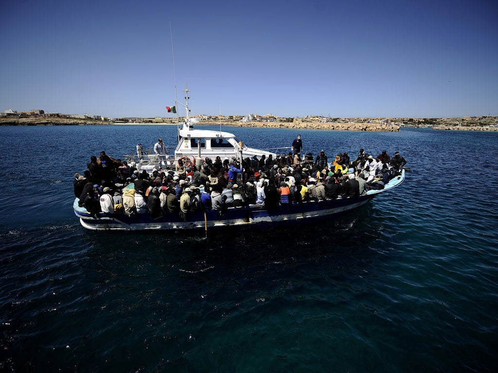 The lucky ones: A boat carrying 200 people from Libya arrives in Italy last year