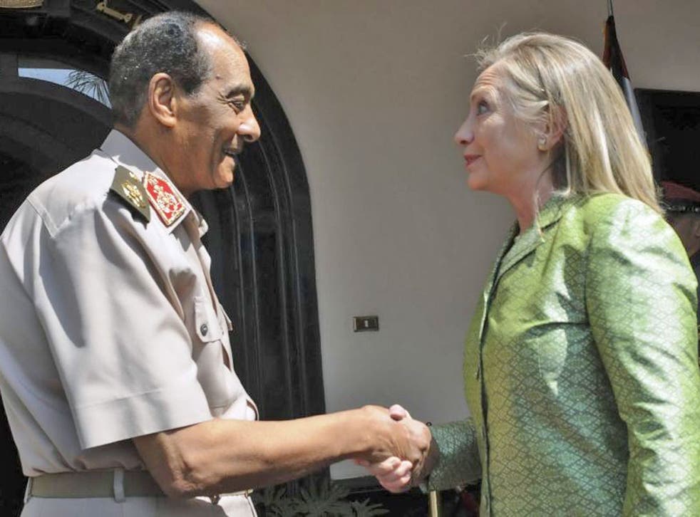 Egyptian military chief Field Marshal Mohamed Hussein Tantawi (left) shakes hand with U.S. Secretary of State Hillary Clinton before their meeting at the Defence Ministry in Cairo yesterday
