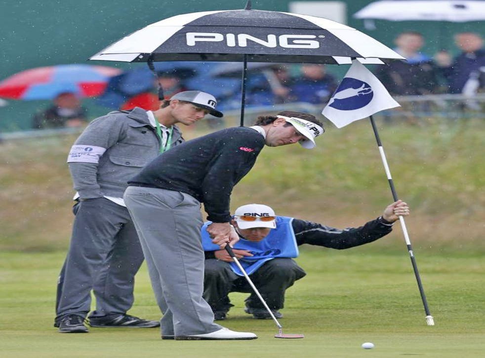Bubba Watson putts during a rainy practice session yesterday