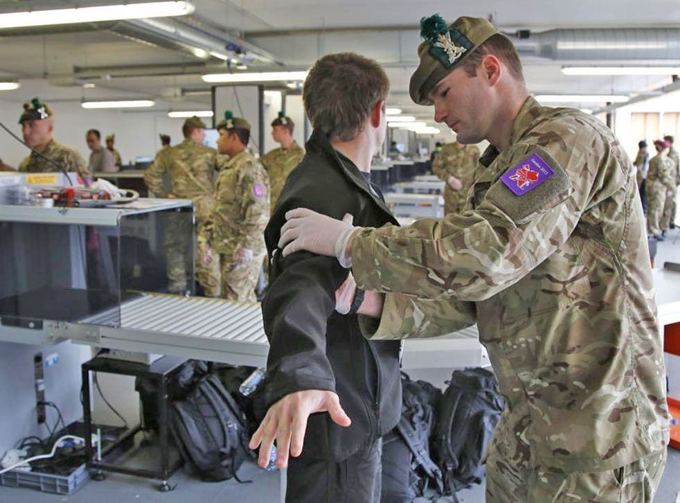 A man is searched by British military personnel at a security check point on arrival at the Olympic Park