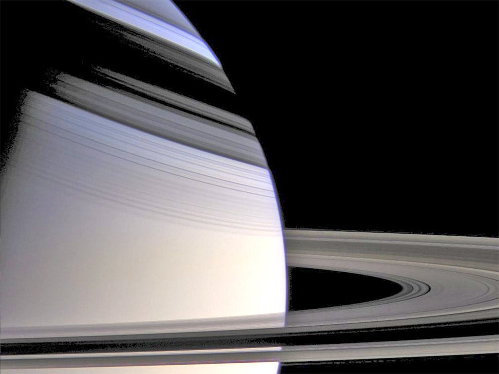 The image shows Saturn and her rings as the rings cast shadows on the planet
