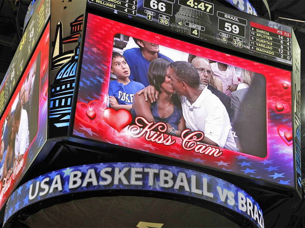 Pucker up: Barack and Michelle Obama smooch on the big screen