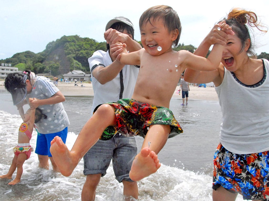 Bathers take the plunge at Nakoso beach, 40 kilometres down the coast from the Fukushima plant