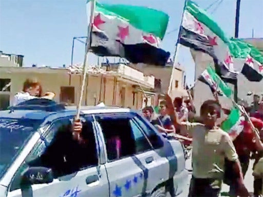 Crowds in Damascus celebrate the news of yesterday’s bomb strikes