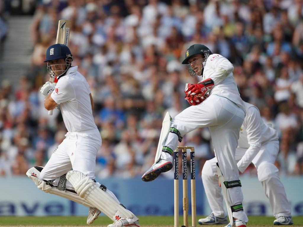 Alastair Cook executes a cut shot as AB De Villiers looks on