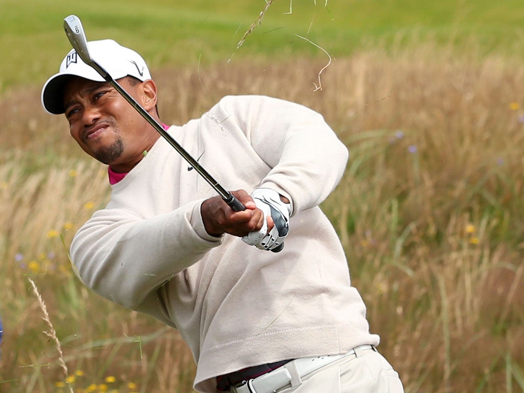Tiger Woods hits out of the rough on the 15th hole yesterday. The detour ended up costing him a dropped shot