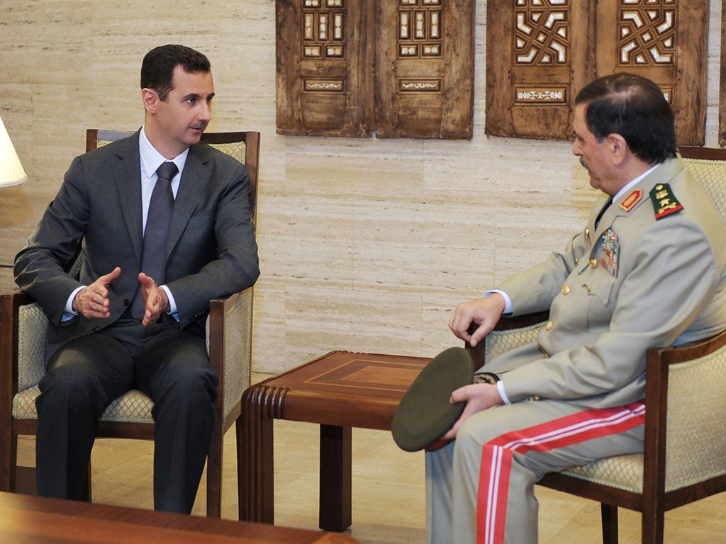 Syrian President Bashar al-Assad, left, and his new Defence Minister, Fahad Jassim al-Freij, in Damascus yesterday