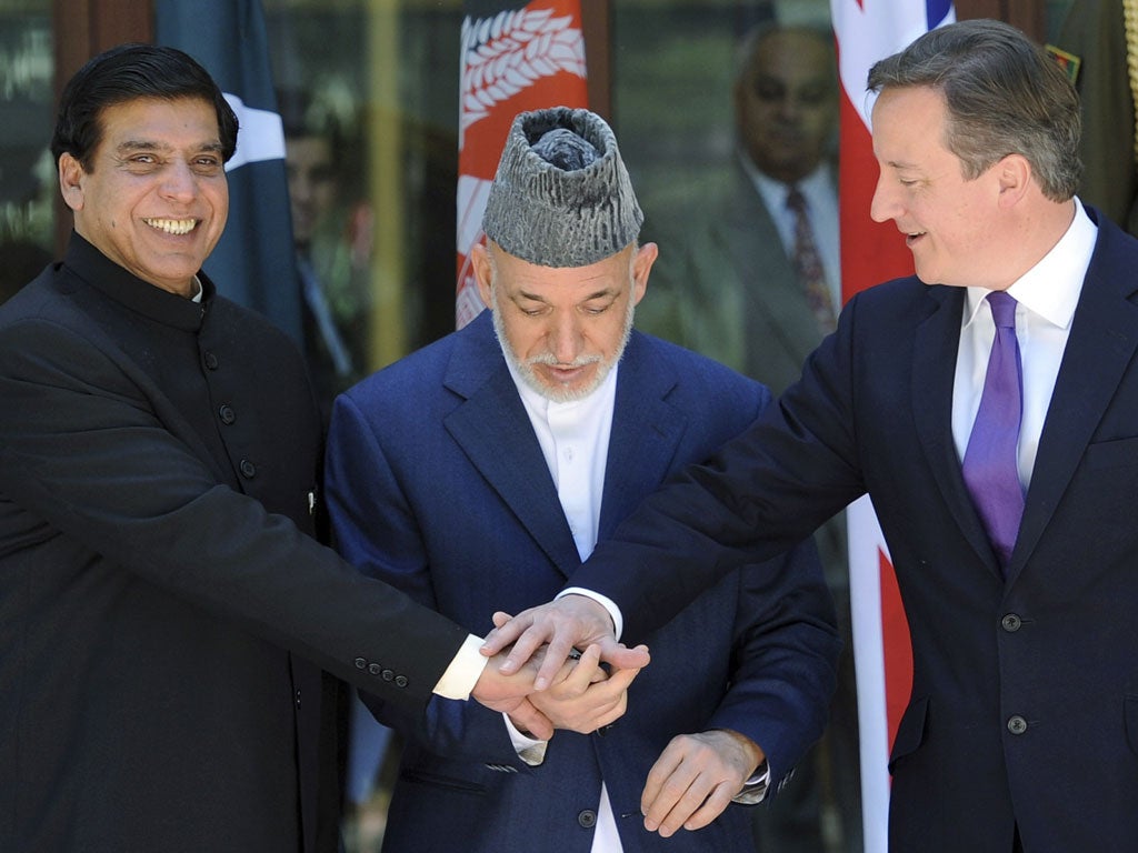 Pakistan's Prime Minister Raja Ashfraf with Hamid Karzai and David Cameron in Kabul yesterday