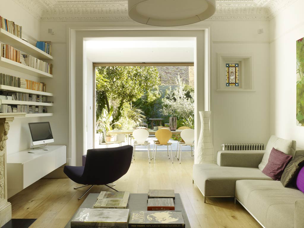 Inside out: The original Victorian living-room, with its ornate stained-glass
window, leads through to a kitchen-diner extension and the garden beyond, all situated on exactly the same floor level