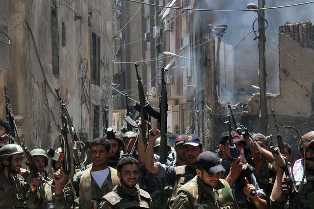 Regime troops celebrate after taking Midan in Damascus