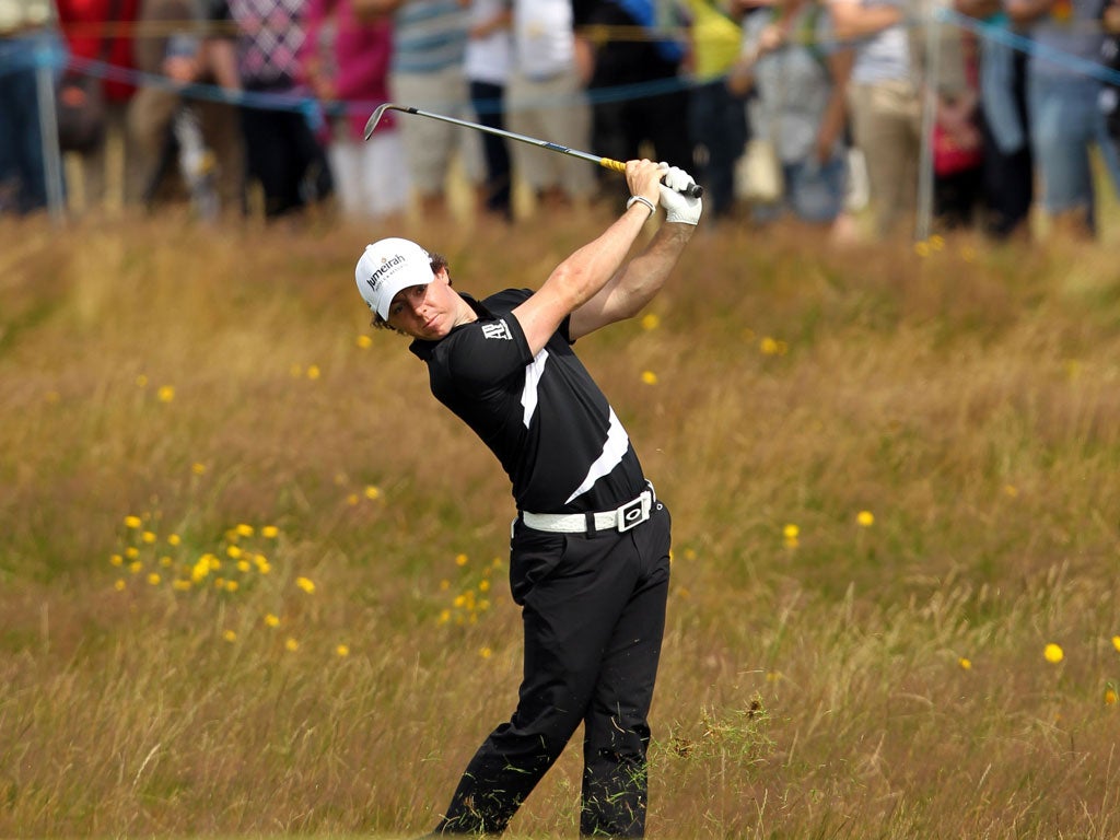 Major problems: Rory McIlroy plays from the sixth fairway during his third round at the British Open yesterday, which he finished with a 73
