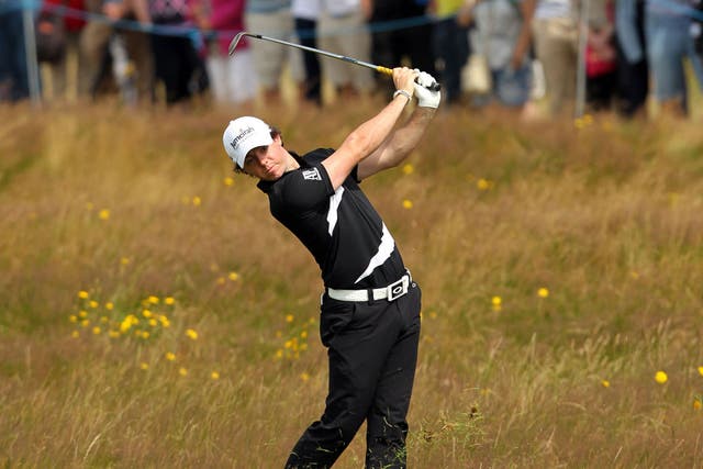 Major problems: Rory McIlroy plays from the sixth fairway during his third round at the British Open yesterday, which he finished with a 73