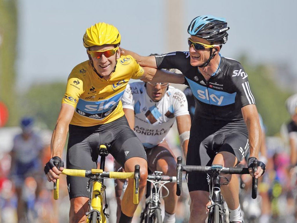 Bradley Wiggins (left) is congratulated by Sky team-mate Michael Rogers after crossing the finishing line in Paris