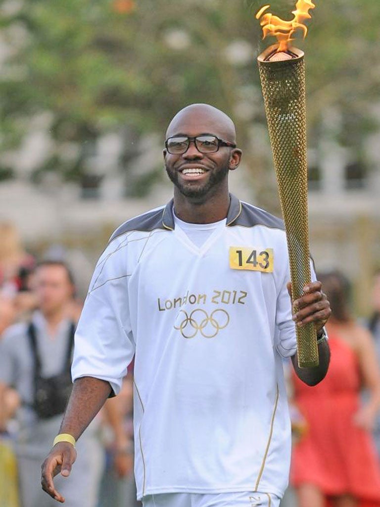 Footballer Fabrice Muamba carries the torch in Tower Hamlets