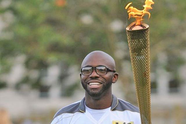 Footballer Fabrice Muamba carries the torch in Tower Hamlets