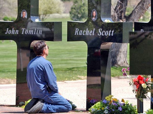 A mourner at the permanent memorial to the victims of the Columbine High School shooting