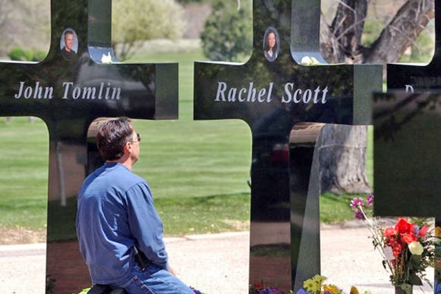 A mourner at the permanent memorial to the victims of the Columbine High School shooting