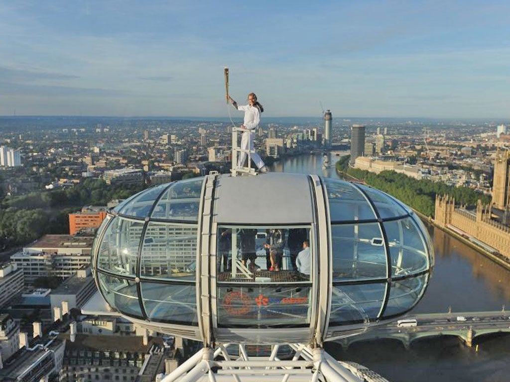 Torchbearer Amelia Hempleman-Adams, 17, standing on top of a London Eye's capsule