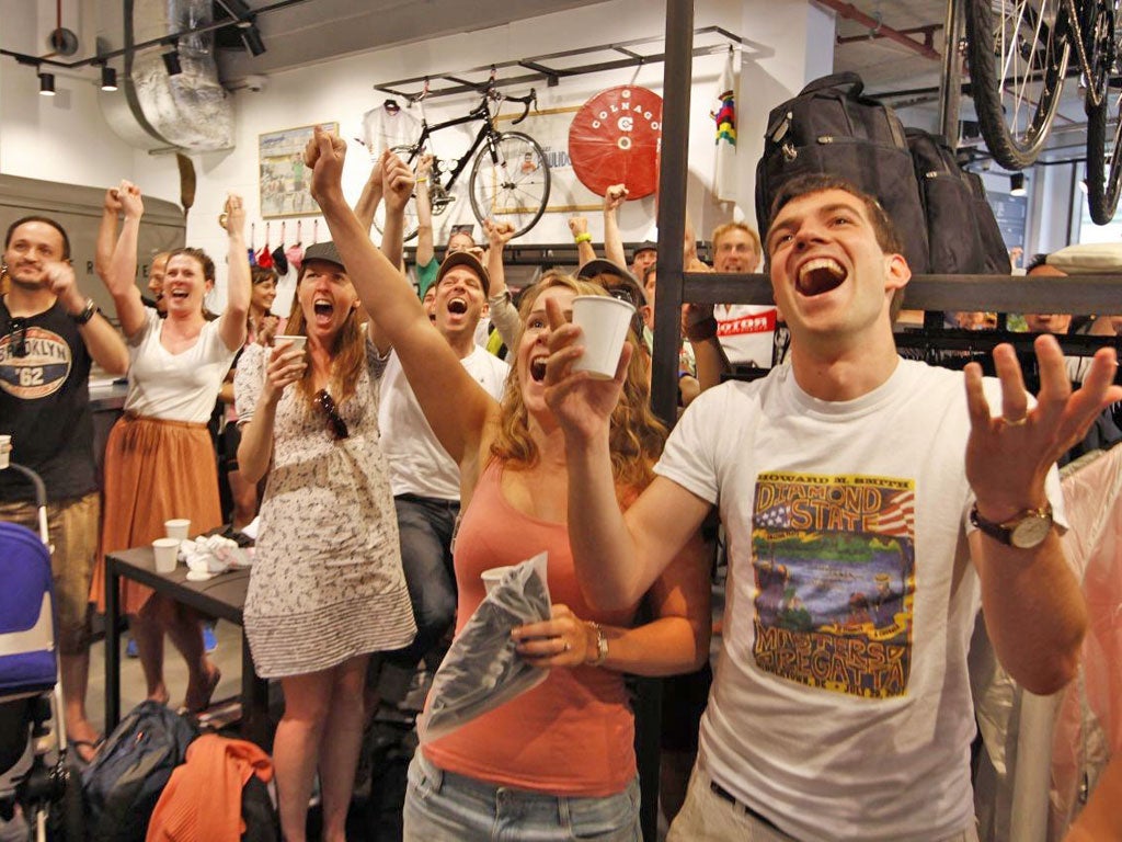 Fans enjoy the end of the Tour de France at the new Rapha café in London