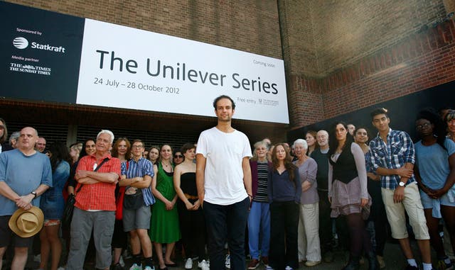 Artist Tino Sehgal is photographed with his participants outside Tate Modern in London.