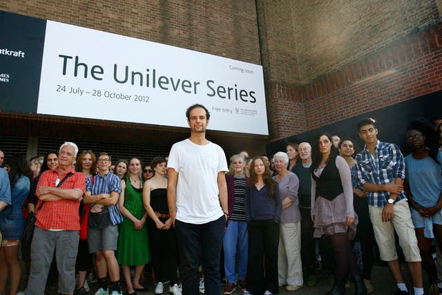 Artist Tino Sehgal is photographed with his participants outside Tate Modern in London.