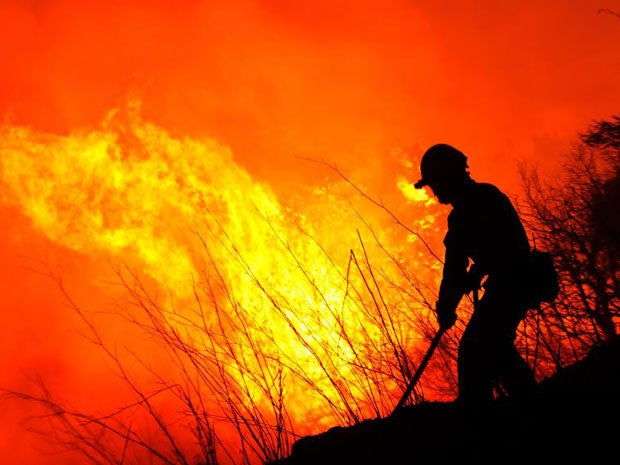 A firefighter tries to extinguish a wildfire in Ller near La Junquera (Girona), close to the Spanish-French border