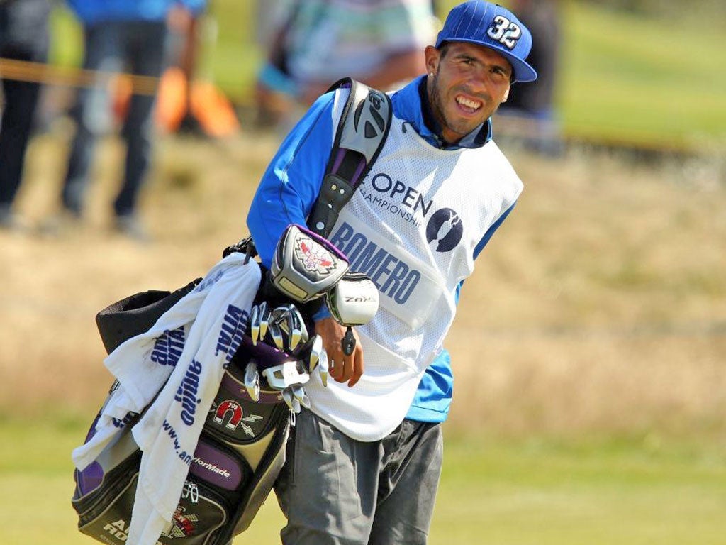 Manchester City's Carlos Tevez turned into a golf caddie for Andres Romero at the Open Championship