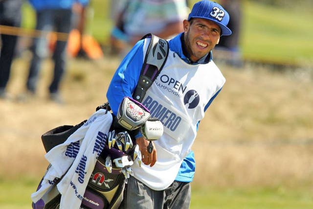 Manchester City's Carlos Tevez turned into a golf caddie for Andres Romero at the Open Championship