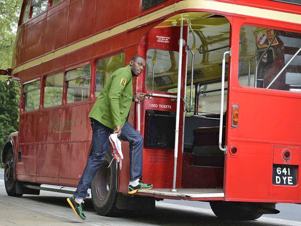 Usain Bolt, the Jamaican sprinter, poses with his running spikes and official team uniform for the London 2012 Olympic Opening Ceremony during a photo shoot, arranged by his sponsors Puma, beside a Routemaster bus outside the British Museum. Bolt is due t
