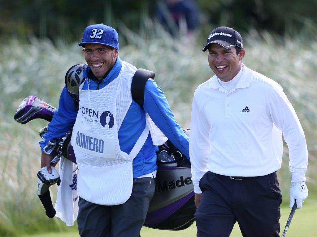 Andres Romero of Argentina and his guest caddie, footballer Carlos Tevez of Manchester City