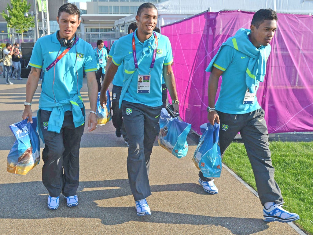 PSG’s new £33m signing Thiago Silva (left) and his Brazil team-mates Juan Jesus and Alex Sandro pick up souvenirs at the Olympic Park