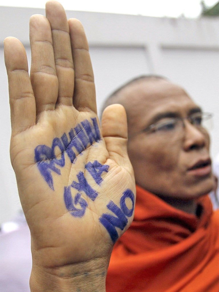 A monk shows an anti-Rohingya slogan on his hand