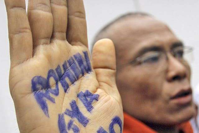 A monk shows an anti-Rohingya slogan on his hand