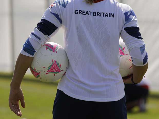Great Britain women's football team goal keeper Rachel Brown holds two balls during a soccer team training in Cardiff