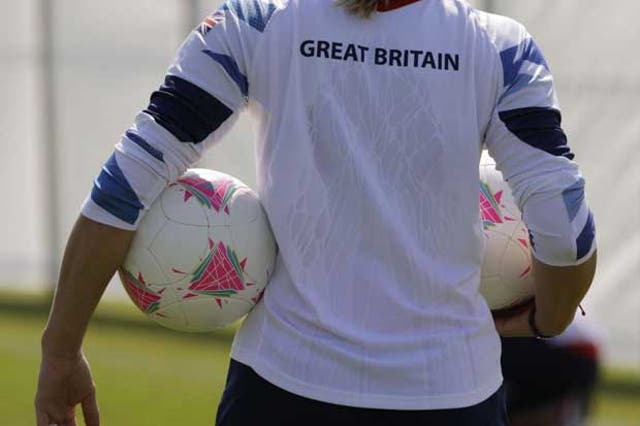 Great Britain women's football team goal keeper Rachel Brown holds two balls during a soccer team training in Cardiff
