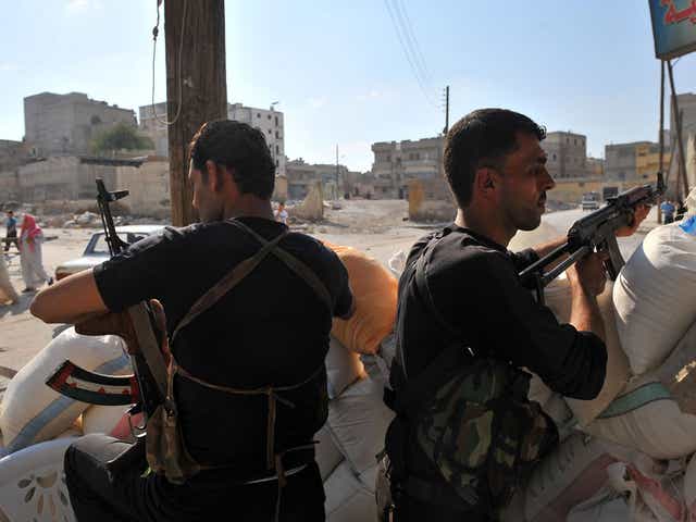 Syrian rebels man a checkpoint in the northern city of Aleppo yesterday