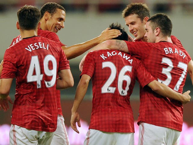 Shinji Kagawa is congratulated by his team mates