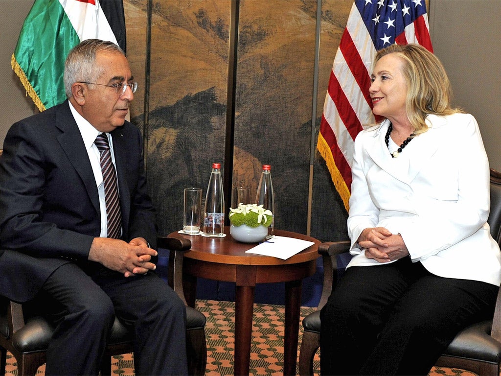 Salam Fayyad speaks with Hillary Clinton earlier this month