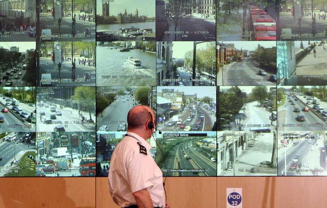 Middle-class crime and punishment: Police officer observing CCTV camera network
