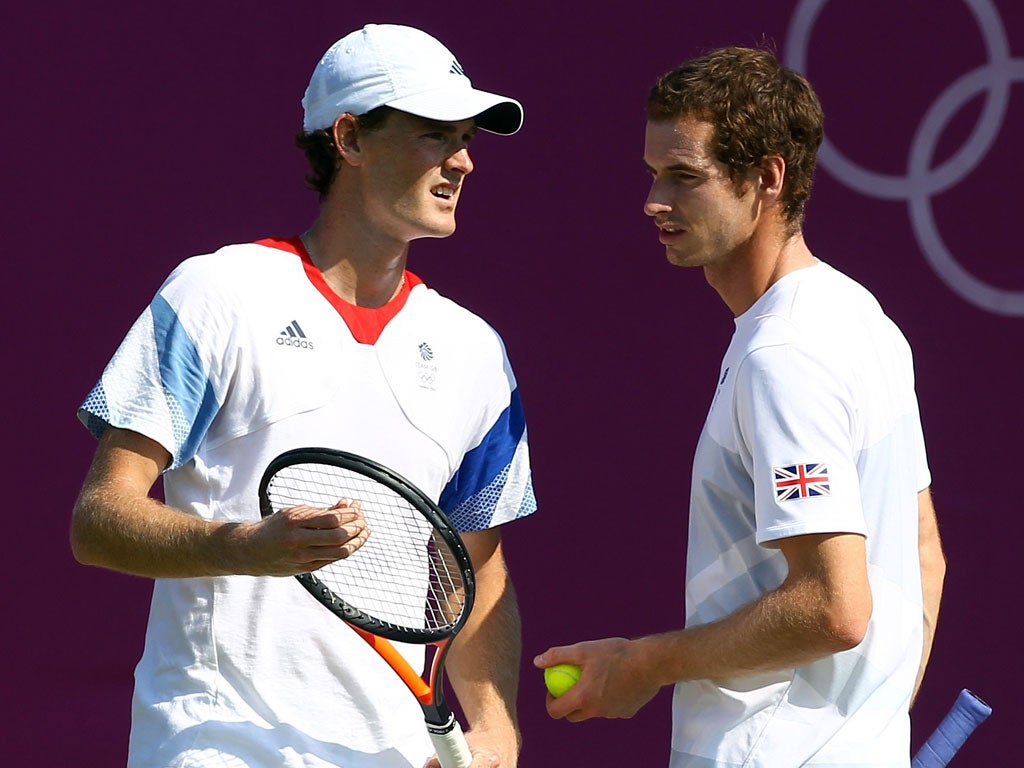 Andy Murray (right) chats with brother Jamie during practice at Wimbledon yesterday