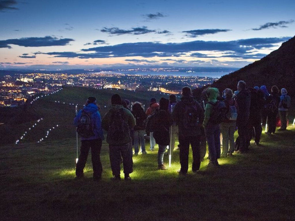 Walkers reach the summit of Arthur's Seat in the Festival event 'Speed of Light'