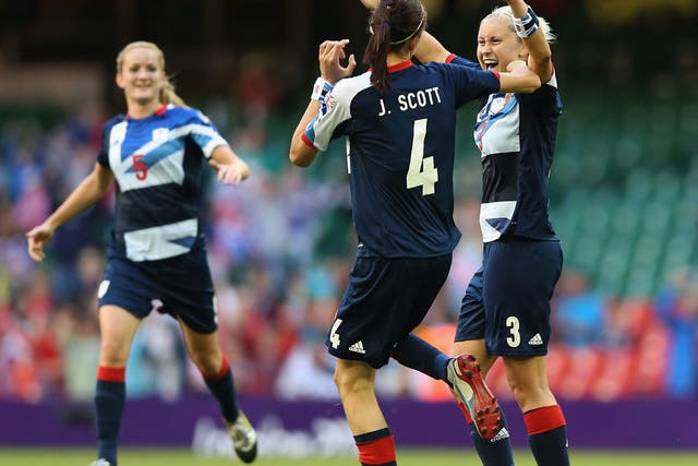 Handy work: Jill Scott celebrates with Steph Houghton after the defender scores Great Britain's third goal