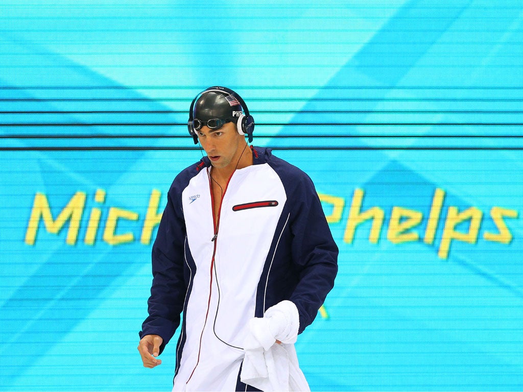 Michael Phelps routinely wears headphones before he swims but is it disrespectful to cheering onlookers?