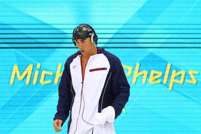 Michael Phelps routinely wears headphones before he swims but is it disrespectful to cheering onlookers?