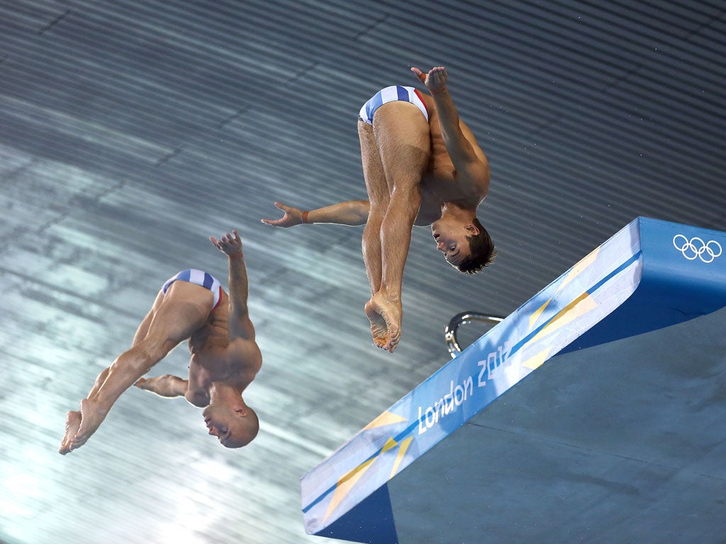 Tom Daley (R) and Peter Waterfield of Great Britain dive during a training session at the Aquatics Centre in Olympic Park