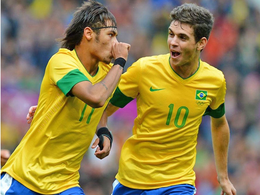 Oscar runs to congratulate Neymar (left) after the Santos striker put
Brazil ahead against Belarus at Old Trafford yesterday